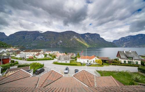 a town with a view of a lake and mountains at Hotel Aurlandsfjord in Aurland