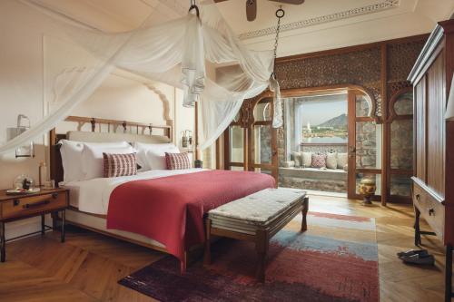 サワイ・マドプールにあるSix Senses Fort Barwara Sawai Madhopurのベッドルーム1室(天蓋付きの大型ベッド1台付)