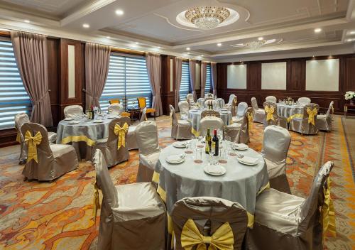 a banquet room with tables and chairs and a chandelier at The Indus Valley in Leh