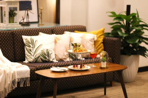 a coffee table with a bowl of food on a couch at Furama City Centre in Singapore