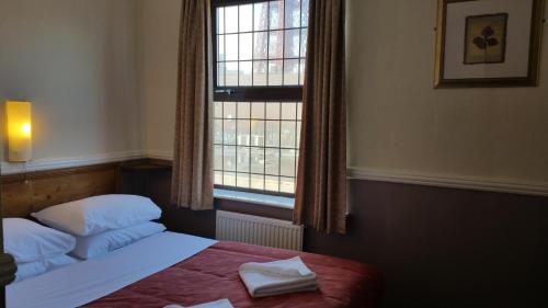 a hotel room with a bed and a window at Westholme Hotel in Blackpool
