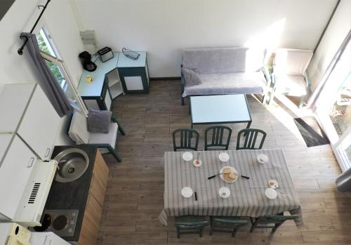 an overhead view of a living room with a table and chairs at Village 17 gites, Piscine, Restaurant , 2 gites avec SPA, 3km de Conques in Conques