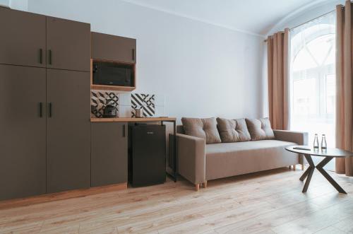 a living room with a couch and a table at Pokoje Venezia in Cieszyn