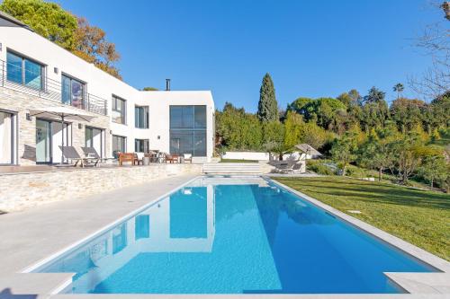 a swimming pool in the backyard of a house at Villa SOHA Bed & Breakfast in Mougins