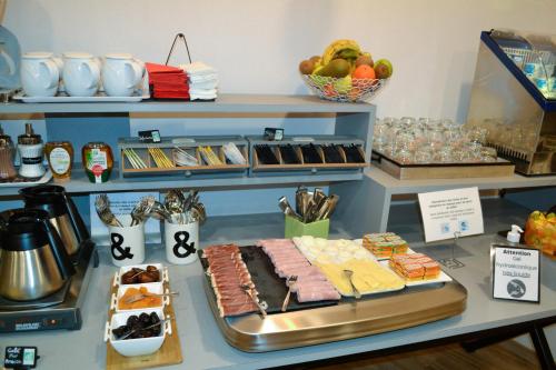 a counter with some food on a table at Hotel Continental in Angers