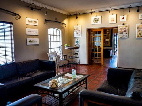 a living room with couches and a coffee table at Londiningi Guesthouse in Windhoek