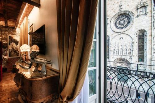 a room with a window looking out onto a balcony at Aurum - Como Luxury Suites in Como
