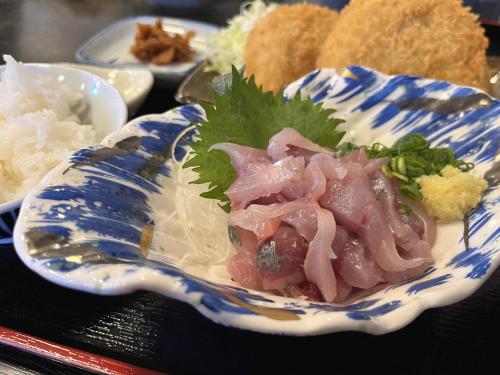 a blue and white plate of food on a table at Ocean View House in Atami