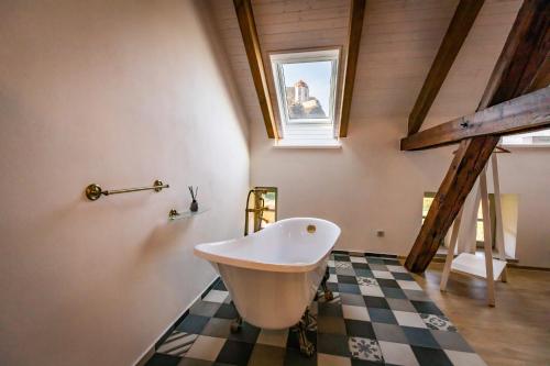 a bathroom with a claw foot bath tub on a checkered floor at Benátky 214 in Vranov nad Dyjí