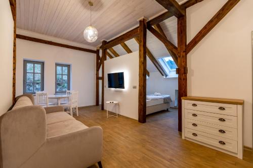 een woonkamer met een bank en een slaapkamer bij Benátky 214 in Vranov nad Dyjí