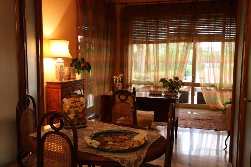 a dining room with a table and chairs and a room with a piano at B&B Il Giardino di Paola in Alliste