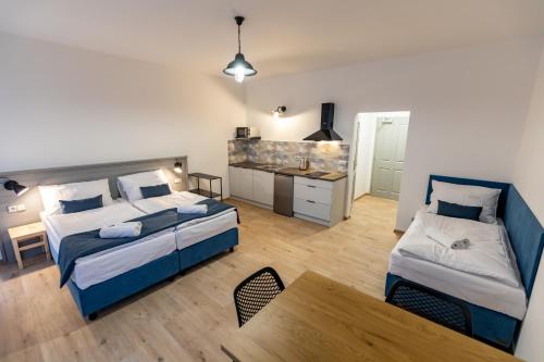 a hotel room with two beds and a kitchen at Benátky 214 in Vranov nad Dyjí