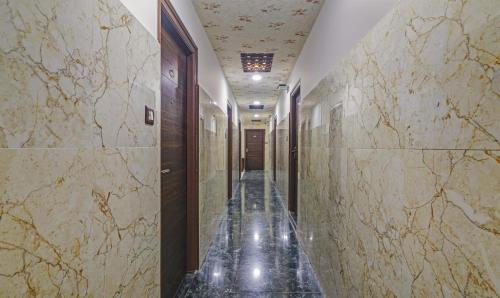 a corridor of a building with marble walls at Itsy Hotels J A Royal Suites Manikonda in Hyderabad