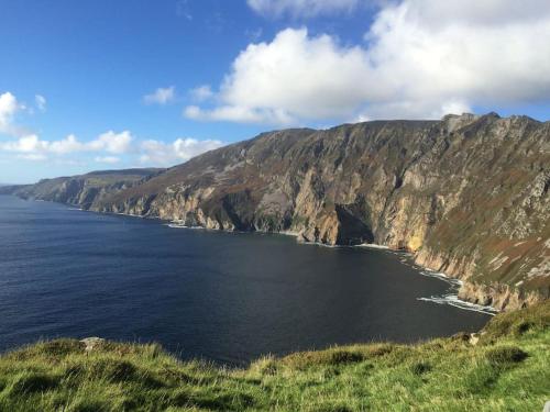 a large body of water next to a mountain at 18 The Mullins in Donegal