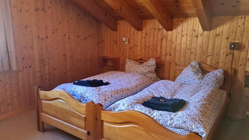 a bedroom with a bed with two shoes on it at Bettmeralp Chalet Zendorn in Bettmeralp