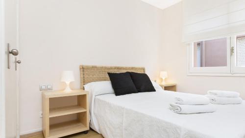 1 dormitorio blanco con 2 camas y ventana en 1 QV - Calella de Palafrugell, en Palafrugell