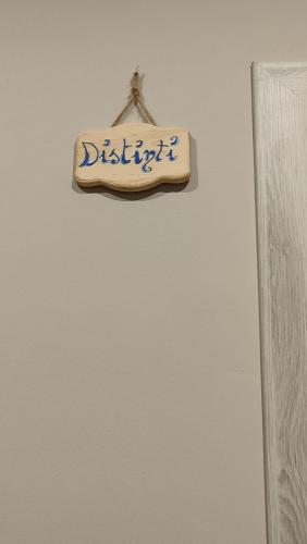 a sign is hanging on a white wall at B&B Stadio in Catanzaro