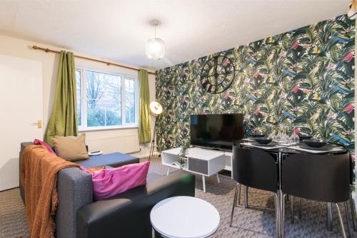 a living room with a couch and a tv at 3-Bed House in Coventry with Free Parking & Private Garden By Sublime Stays in Parkside