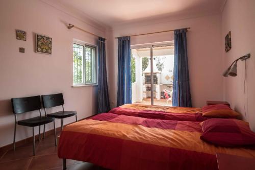 a bedroom with a bed and a window at Casa da Alcaria by Portucasa in Altura
