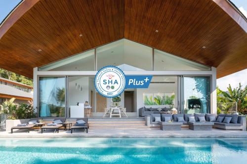 a resort with a swimming pool and a building at Himmapana Villas - Terraces - SHA Extra Plus in Kamala Beach