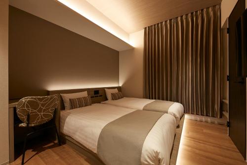 a hotel room with two beds and a window at fav ISE in Ise