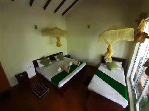 Postel nebo postele na pokoji v ubytování Banana Rest Sigiriya