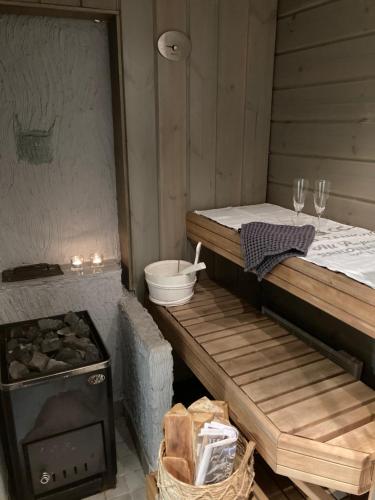 a room with a bed and a stove and glasses at Villa Pyhäjärvi in Tampere