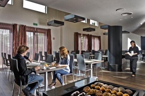 a group of people sitting at tables in a room at Hotel Alimara in Barcelona