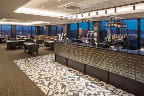 a restaurant with a bar with a view at Crowne Plaza Plymouth by IHG in Plymouth