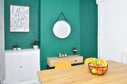 a dining room with a table with a bowl of fruit at The Yellow Door by Avenew Management Serviced Accommodation in Stoke on Trent