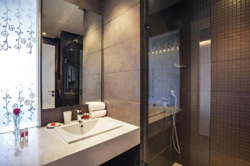 a bathroom with a sink and a shower at Relax Hotel Kenitra in Kenitra