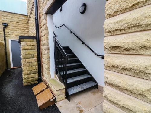 a staircase in a building with a brick wall at Market Lounge in Clitheroe