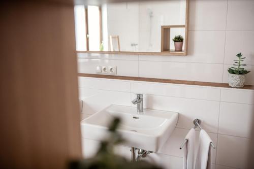a bathroom with a sink and a mirror at M-House FLACHAU Ganzes Haus für 8 Personen in Flachau