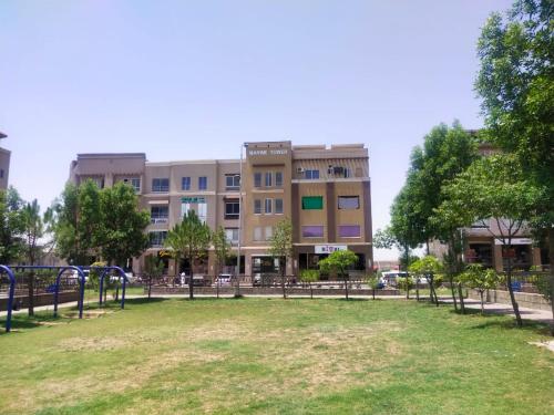 a park in front of a large building at Marine Tower in Rawalpindi