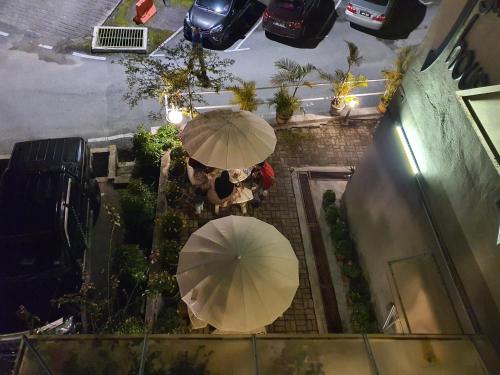 an overhead view of two umbrellas on a staircase at Fathers Guesthouse in Cameron Highlands