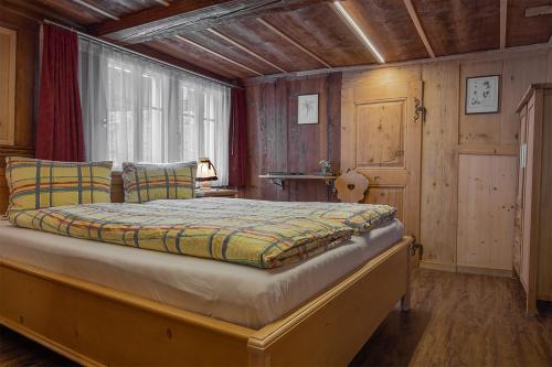 a bedroom with a large bed in a room at Hotel-Restaurant Drei Tannen in Niederwald