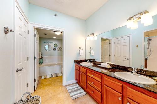 a bathroom with two sinks and a large mirror at Paradise Shores 305 in Mexico Beach