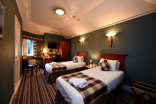 Ένα ή περισσότερα κρεβάτια σε δωμάτιο στο Savoy Park Hotel
