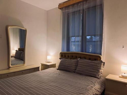a bedroom with a bed and a large mirror at Apartament Aretta in Braşov