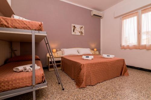 a bedroom with two bunk beds and a window at Hotel Lydia in Cervia