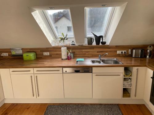 a kitchen with a sink and a window at Ferienwohnung Nussbaum-Nest in Hausen