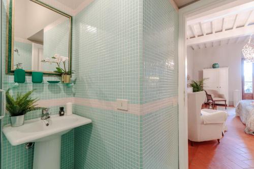 a bathroom with a sink and a mirror at Villa Chianti, your Secret 4 Bedrooms Retreat with View over the Vineyards in Marcialla in Marcialla