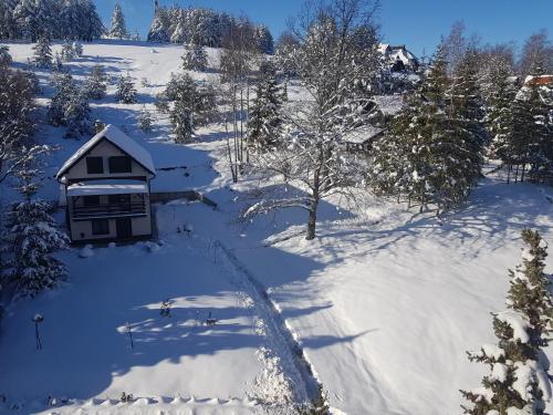 an aerial view of a house in the snow at Botanica Zlatibor in Zlatibor