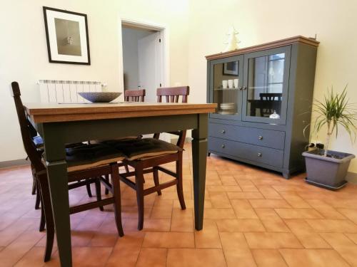 a dining room with a table and chairs and a cabinet at Casa del Moro in Florence
