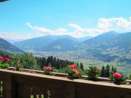 a view of a valley from a balcony with flowers at Apartment Moarerlechenhof-1 by Interhome in Hart im Zillertal
