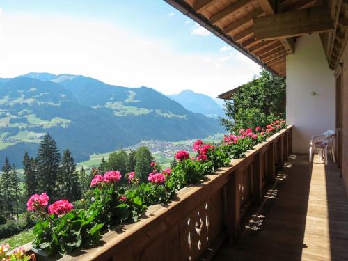 a balcony with flowers and mountains in the background at Apartment Moarerlechenhof-1 by Interhome in Hart im Zillertal