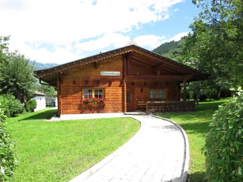 a log cabin with a walkway in front of it at Chalet Heisenhaushütte by Interhome in Ramsau im Zillertal