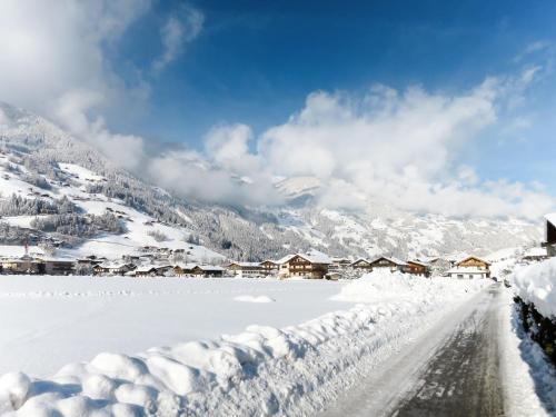a snow covered road in a village with snow covered houses at Apartment Heisenhaus-2 by Interhome in Ramsau im Zillertal
