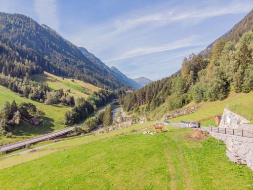 a green field with mountains in the background at Holiday Home Burgner by Interhome in Kappl