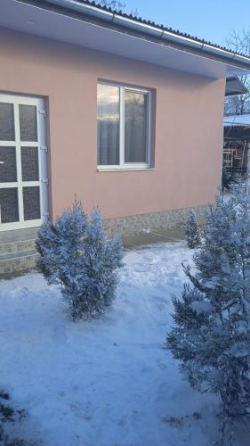 a house with snow on the ground in front of it at Будинок для відпочинку Dana in Berehove